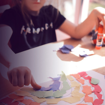 Child plays with different colors of paper